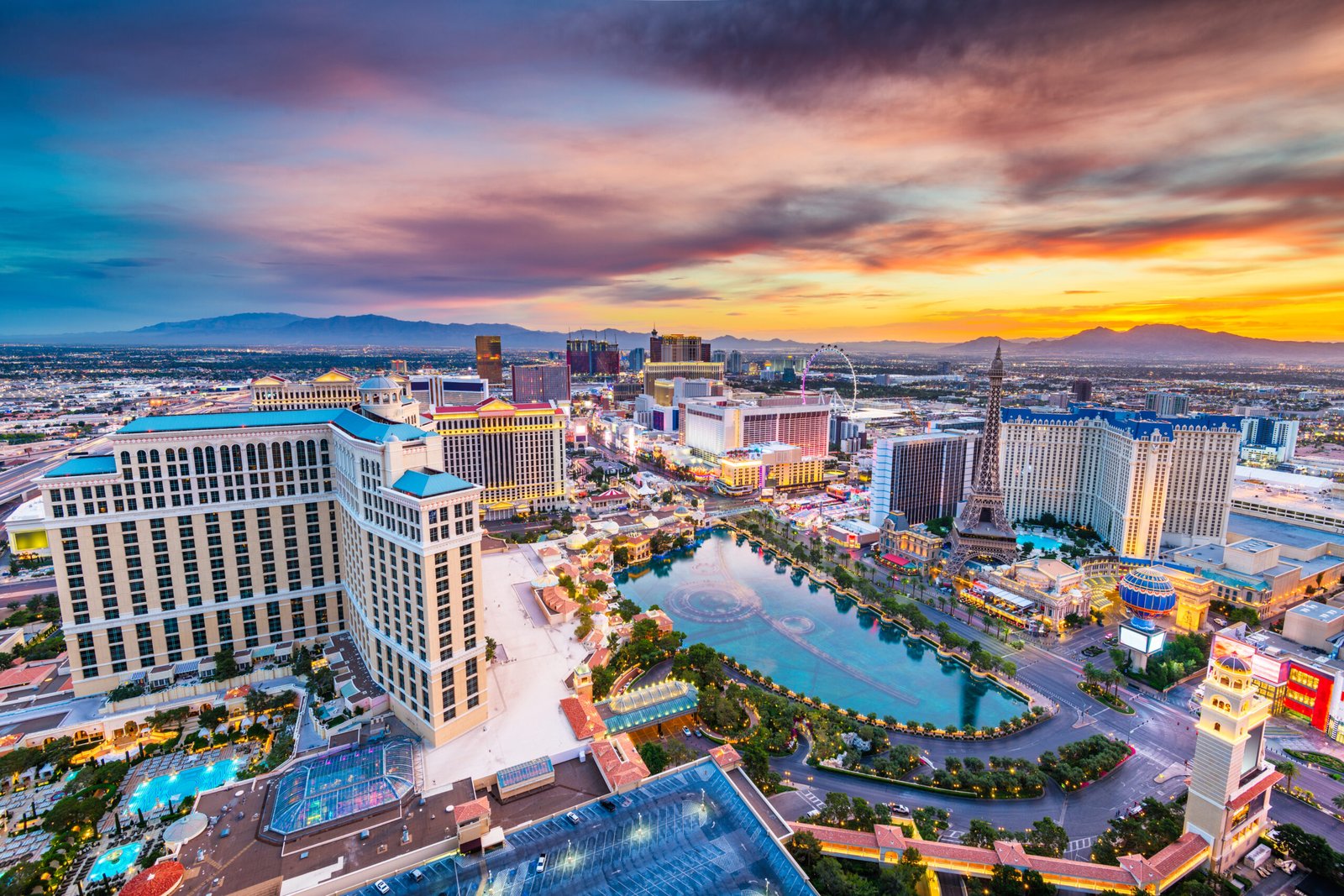 The Las Vegas Strip at dusk with the Bellagio fountains and hotel towers lit up