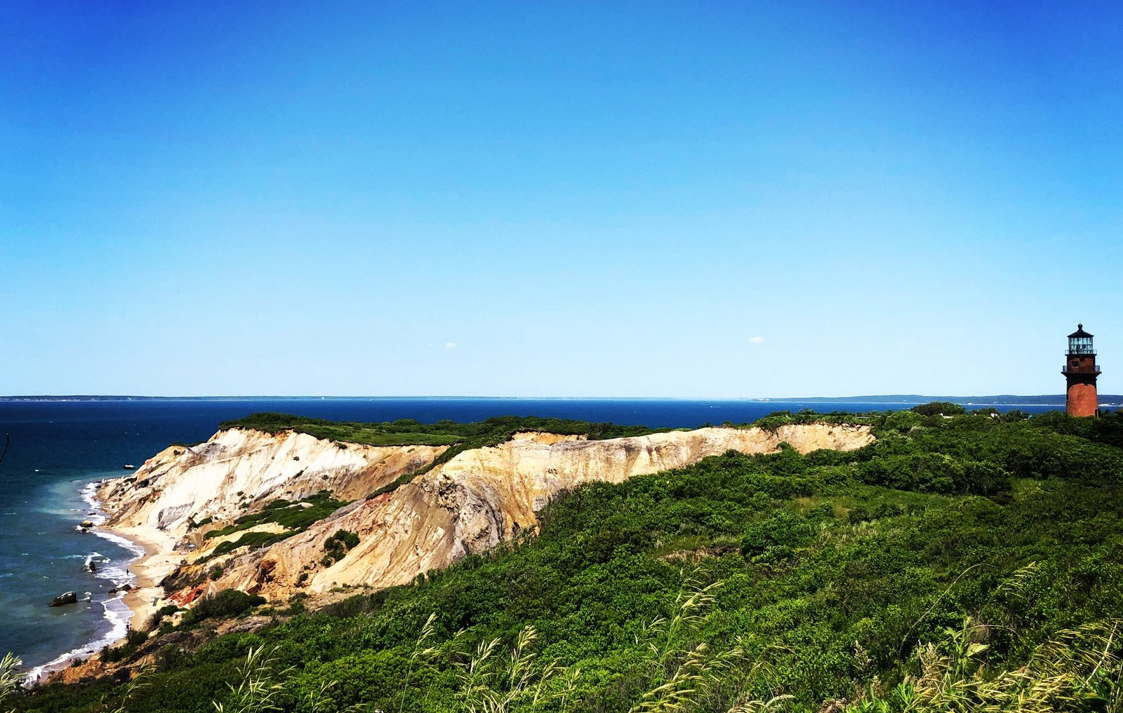 The Aquinnah clay cliffs with the lighthouse on the bluff above the ocean
