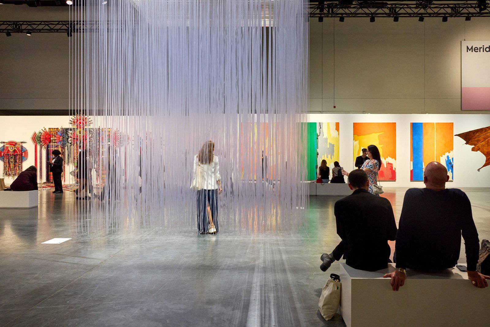 Visitors among installations at an Art Basel Miami Beach exhibition hall