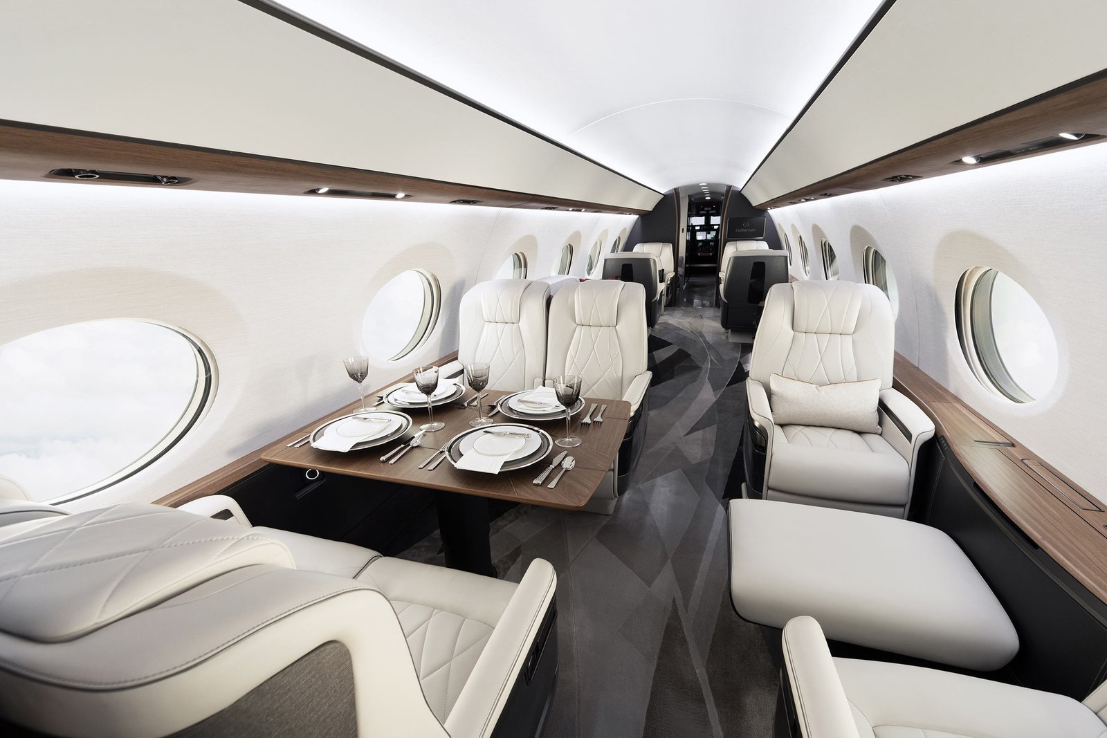 Cabin interior of a large-cabin private jet with the table set for a meal