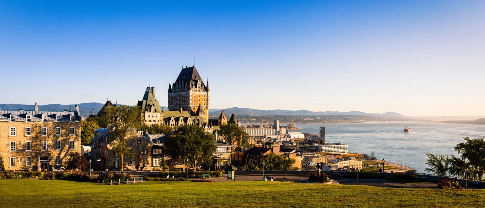 Chateau Frontenac above the St Lawrence River with Old Quebec rooftops below