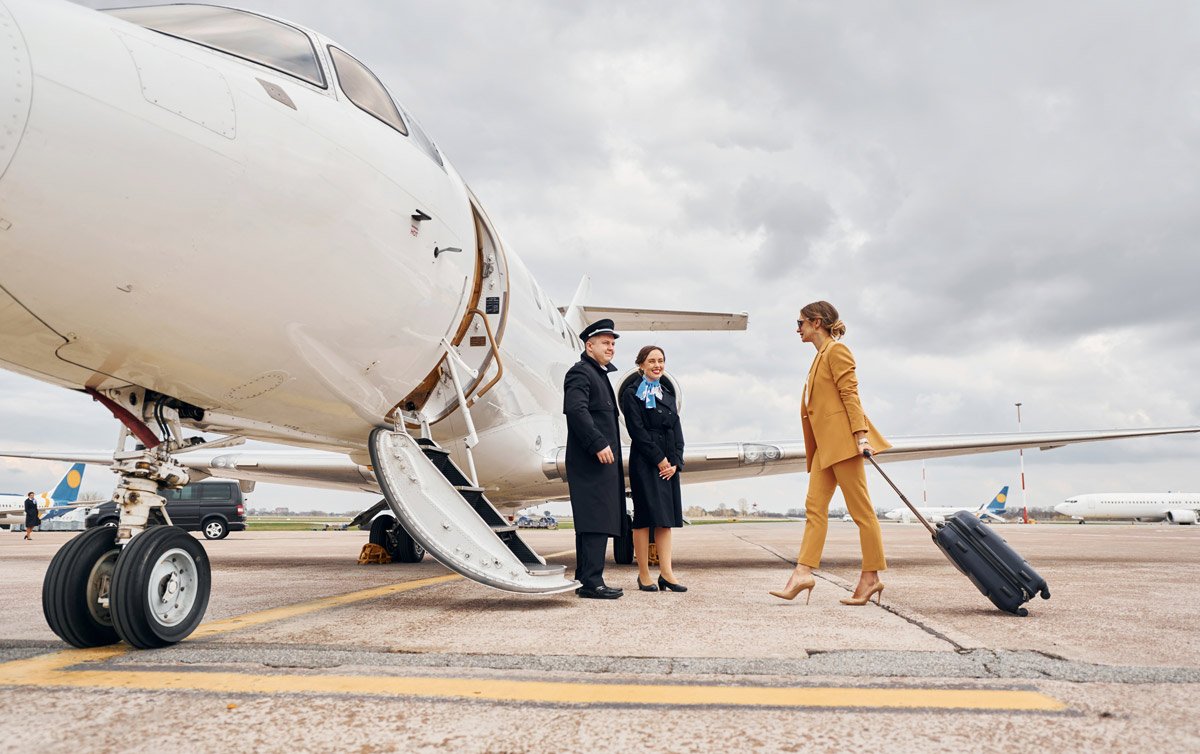 Cabin crew member greeting a passenger aboard a private jet